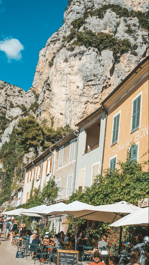 Sunset hitting the village of Moustiers-Sainte-Marie with its famous gold star hanging between two cliffs.