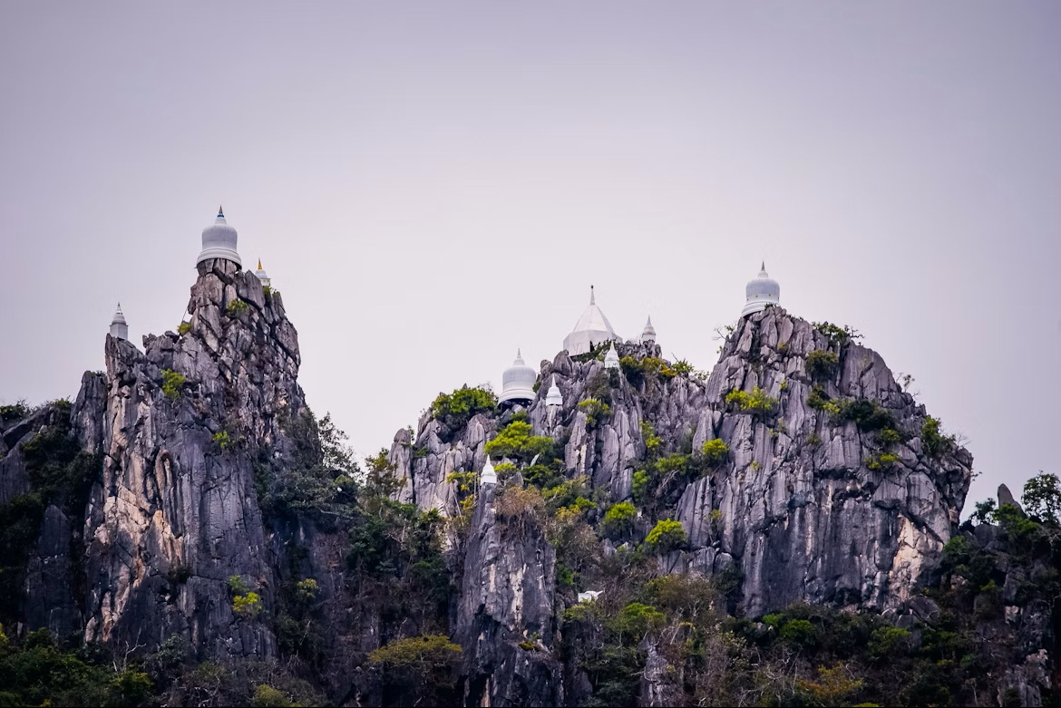 White pagodas of Wat Chalermprakiat Lampang perched on mountain peaks