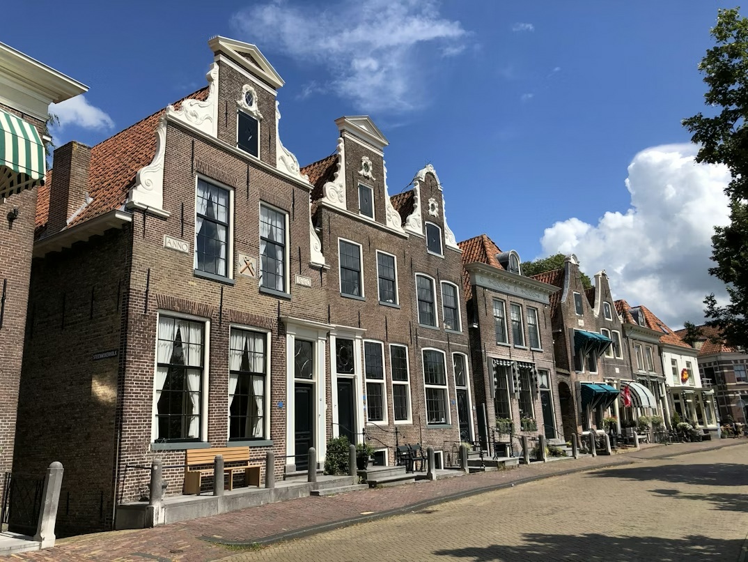 Historic harbor houses in Blokzijl Netherlands along the Amsterdam to Groningen road trip route.