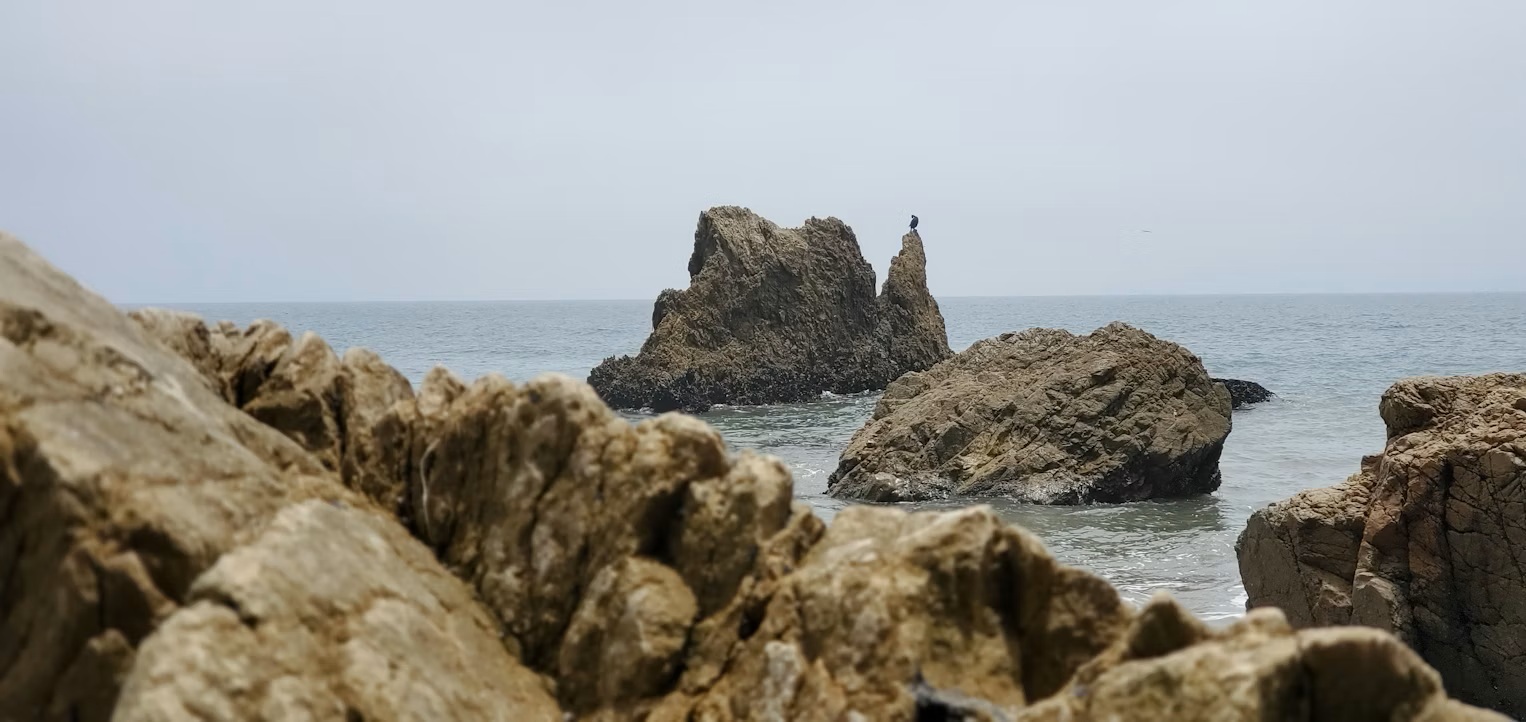 Sea caves and towering rock arches on the shoreline of El Matador State Beach, Malibu