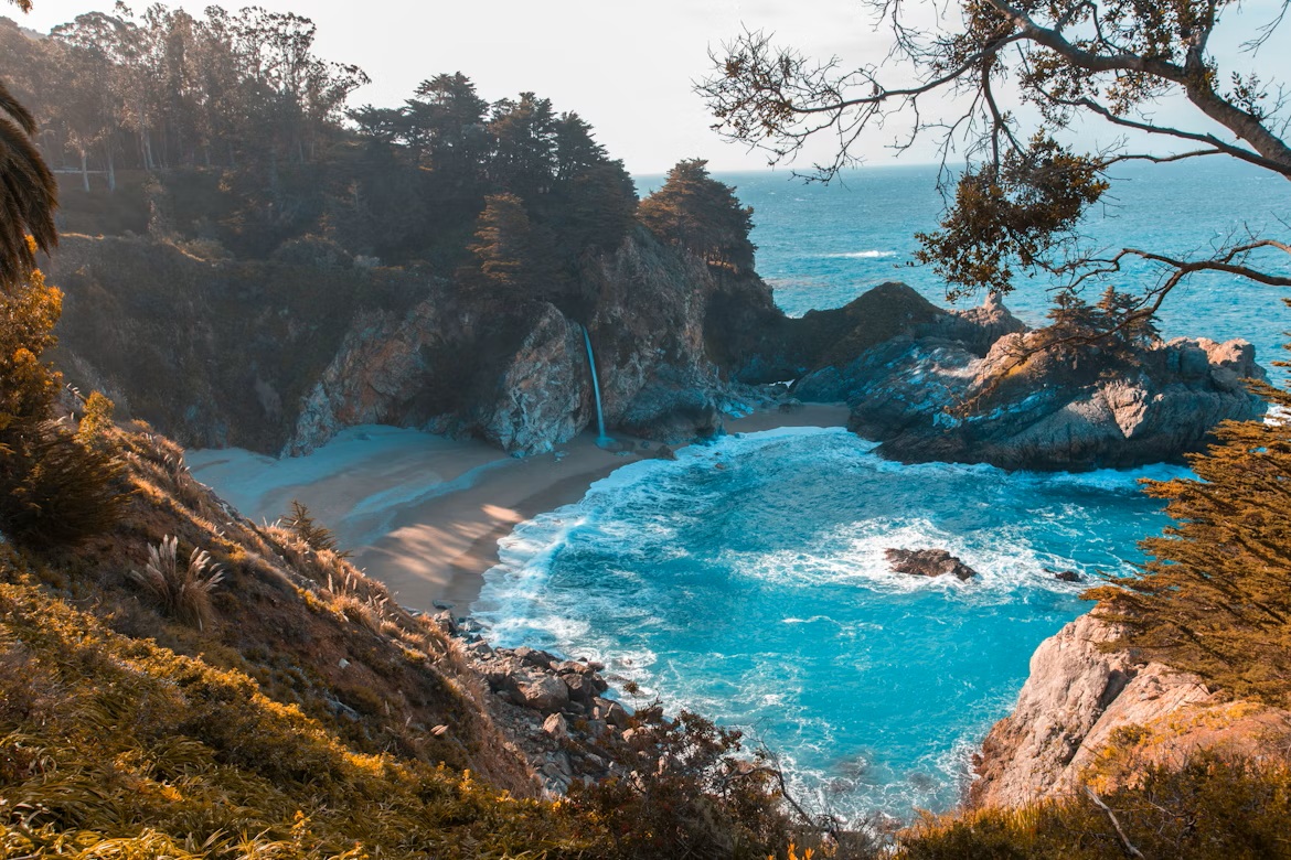 80-foot McWay Falls dropping onto a pristine sandy beach in Big Sur