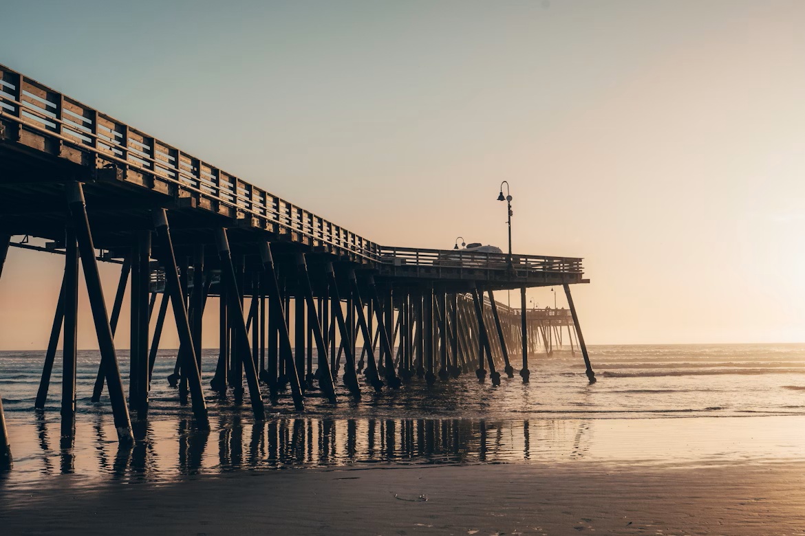 Wide sandy beach and historic pier at Pismo Beach, California