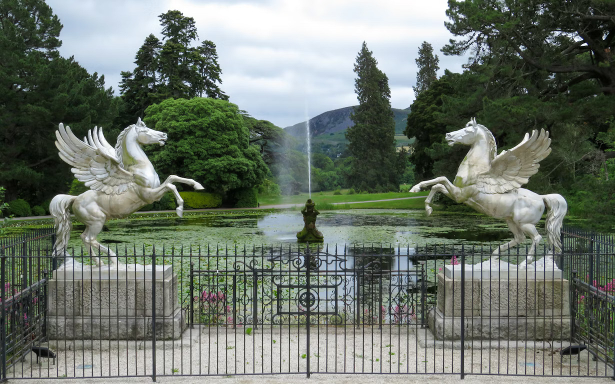 High-angle view of the formal Italianate gardens at Powerscourt Estate with the Wicklow Mountains in the background.