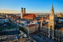 Panoramic view of Munich city center featuring the Frauenkirche domes and New Town Hall — start of the scenic road trip to Salzburg