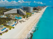 Aerial panoramic view of Cancun Hotel Zone beaches with turquoise Caribbean water and white sand resorts