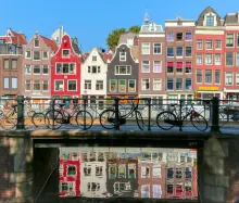 Aerial view of Amsterdam city center with canals, historic buildings, and bridges, Netherlands.