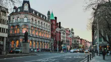 Street view of central Dublin with historic buildings, pedestrians, and city traffic in Ireland’s capital.