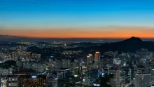 Panoramic view of Seoul skyline surrounded by mountains, the starting point of the Seoul to Gangneung road trip route.
