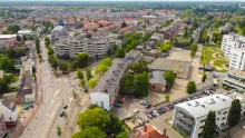 Aerial view of Eindhoven city center with modern architecture, urban streets, canals, and historic buildings in the Netherlands.