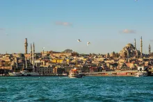 View of Istanbul with the Bosphorus, historic mosques, and the city skyline at sunset in Turkey.