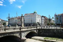 Panoramic view of Sofia city skyline with Alexander Nevsky Cathedral, historic architecture, and the Vitosha Mountains rising in the background.