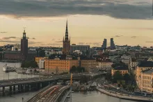 Panoramic view of Stockholm with its waterfront, historic Gamla Stan old town, colorful buildings, bridges, and Baltic Sea reflections under soft Nordic evening light in Sweden.