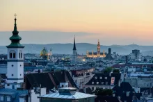 Panoramic view of Vienna with St. Stephen’s Cathedral, historic architecture, and the Danube River in Austria.