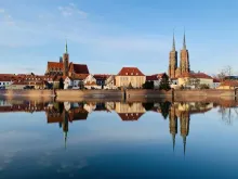 View of Wroclaw Market Square with colorful historic townhouses and Gothic architecture in Poland.