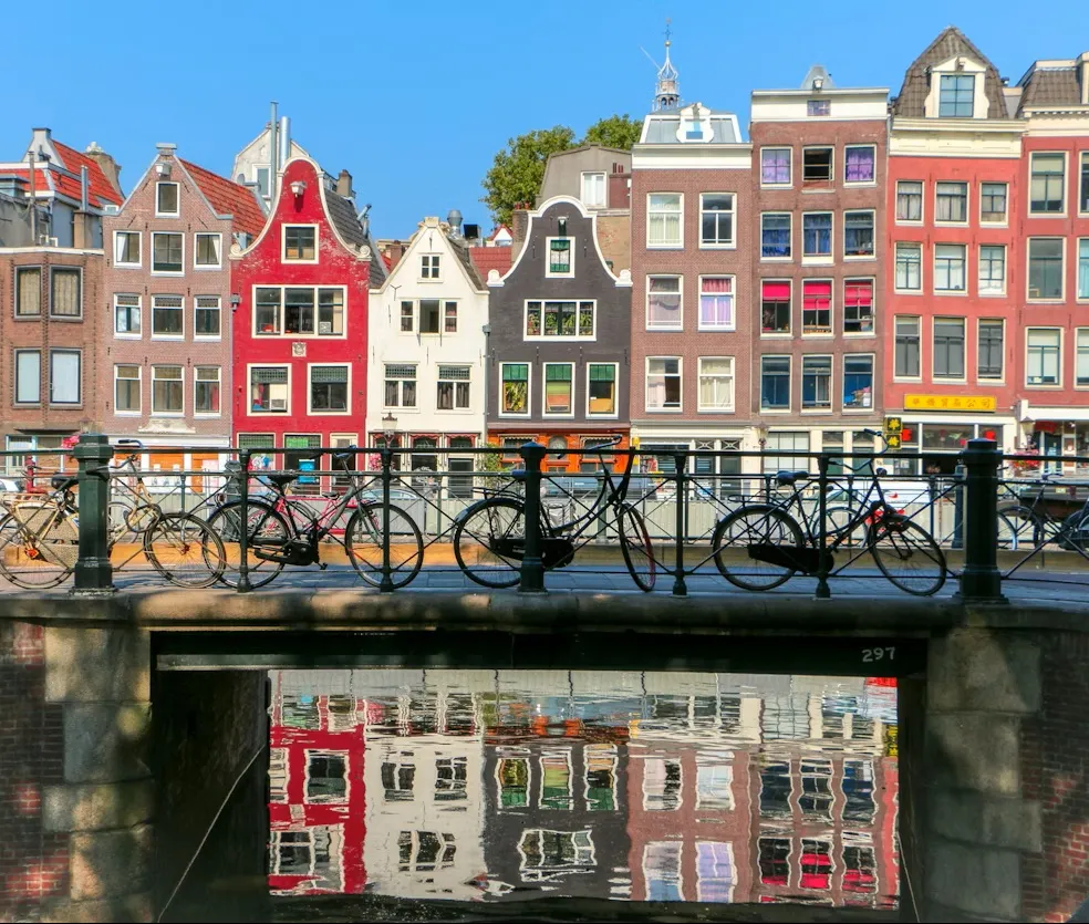 Aerial view of Amsterdam city center with canals, historic buildings, and bridges, Netherlands.