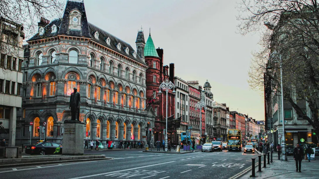 Street view of central Dublin with historic buildings, pedestrians, and city traffic in Ireland’s capital.