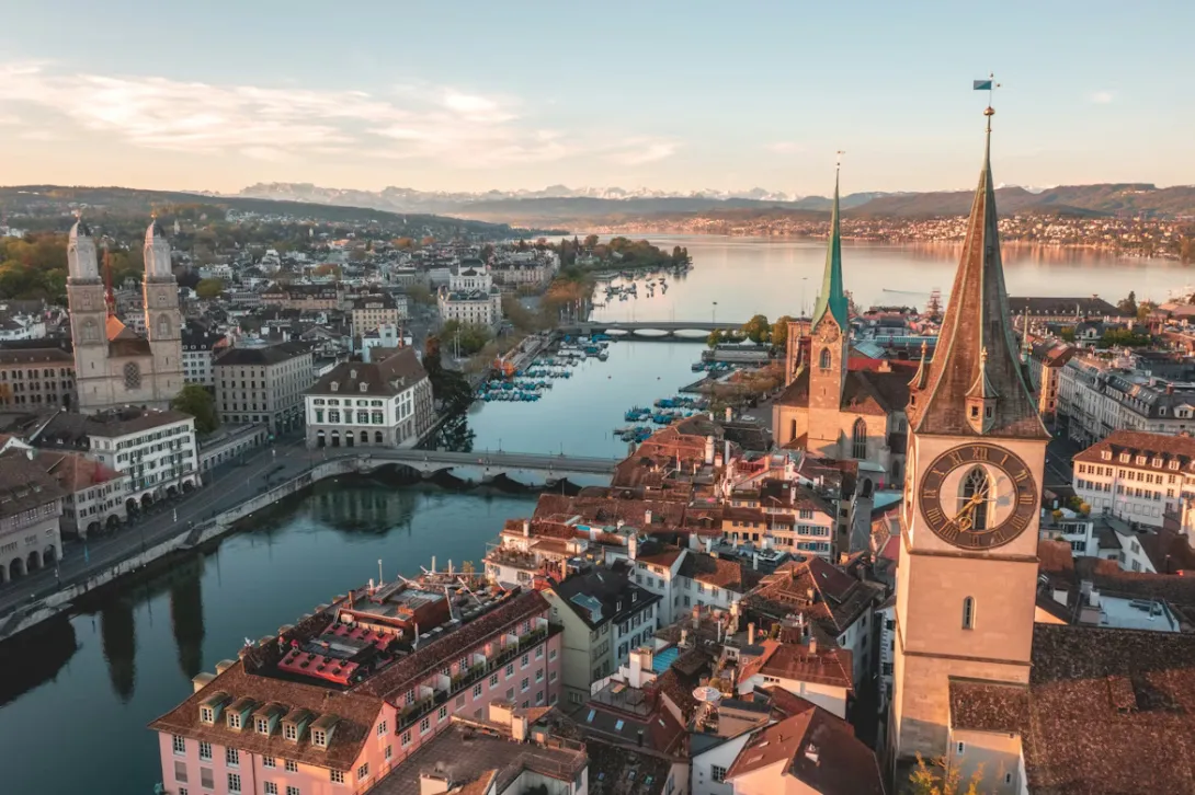 Zurich city panorama with lake, historic old town, and Swiss Alps in the background for a Zurich to Berlin road trip guide