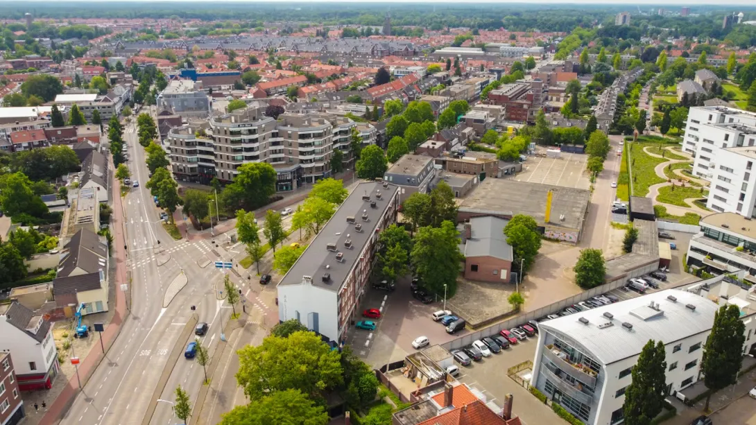 Aerial view of Eindhoven city center with modern architecture, urban streets, canals, and historic buildings in the Netherlands.