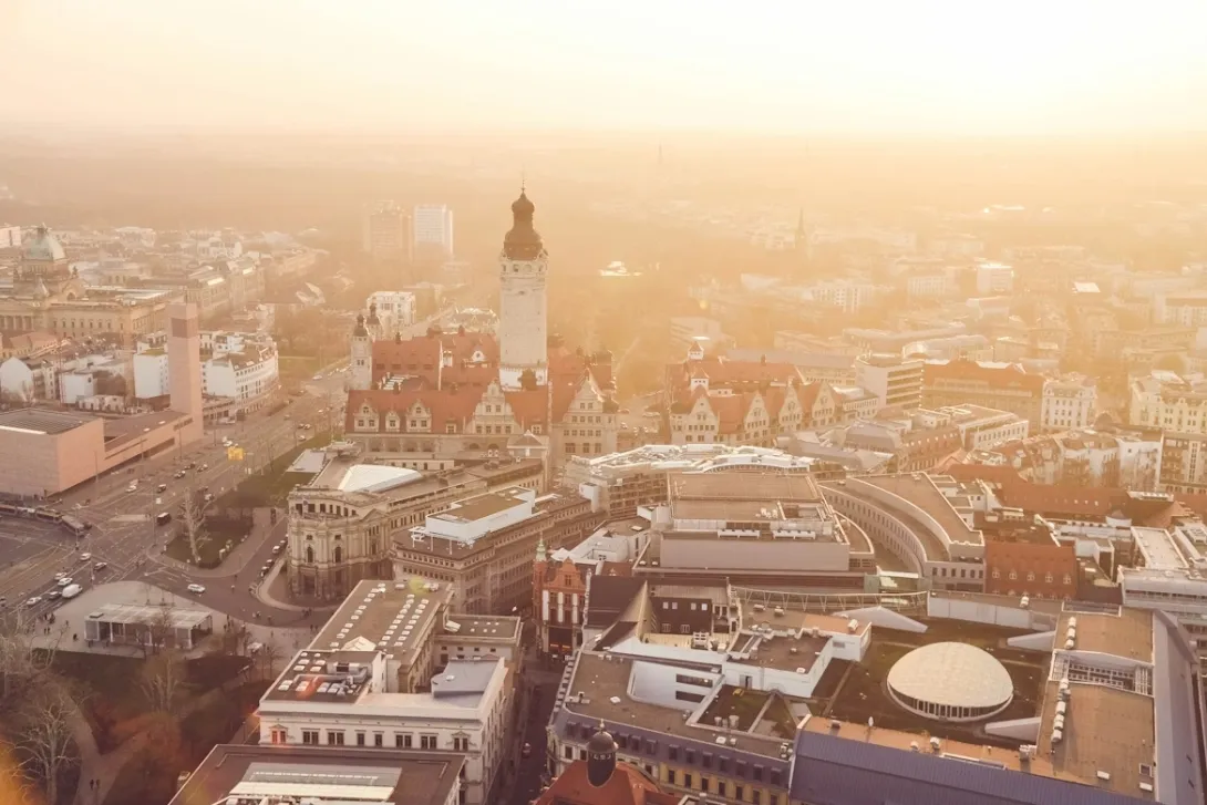 Panoramic view of Leipzig with historic buildings, church towers, and vibrant city streets in Germany.