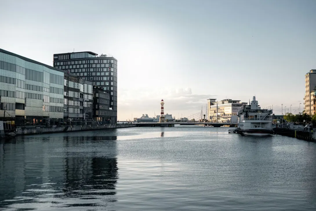 Panoramic view of Malmo waterfront with modern architecture, colorful buildings, and the Oresund Bridge in Sweden.