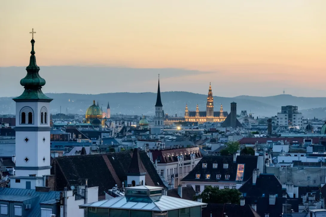 Panoramic view of Vienna with St. Stephen’s Cathedral, historic architecture, and the Danube River in Austria.
